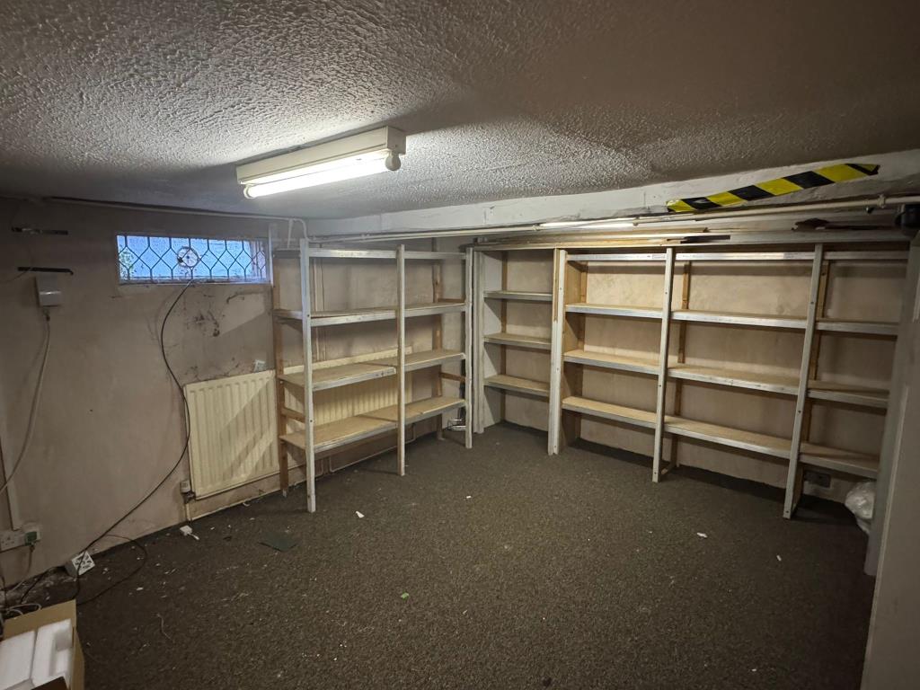 Lot: 88 - FREEHOLD COMMERCIAL PROPERTY ON HIGH STREET - Basement with lighting and storage racks